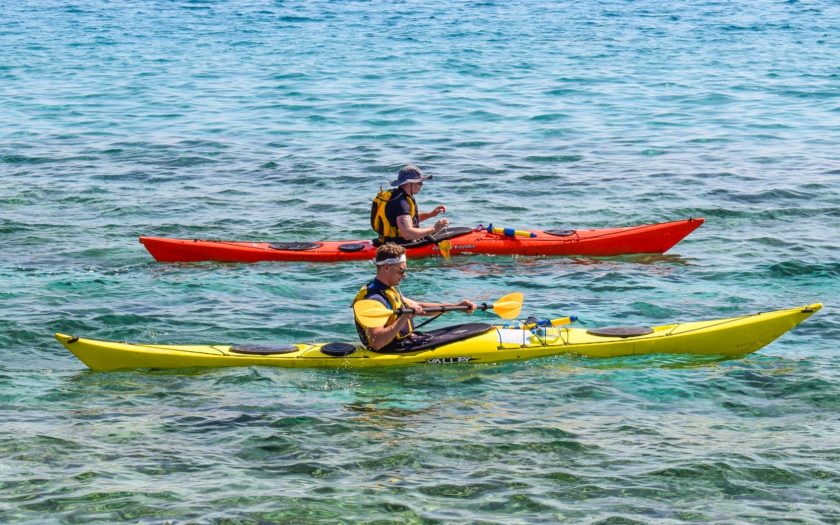 men kayaking in ocean