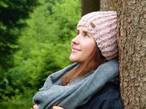 women leaning to tree